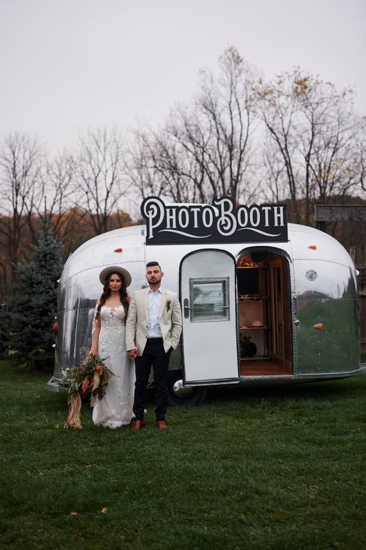 The 1961 Airstream Bambi photo booth set up at a wedding